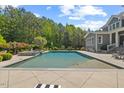 Private pool with a relaxing spa area and surrounded by lush landscaping at 219 Colvard Park Dr, Durham, NC 27713