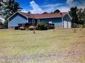 Back of house with a deck and a two-car garage at 22 Woodridge Ln, Cameron, NC 28326