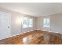 Open-plan living room with hardwood floors and neutral paint color at 2453 Derby Dr, Raleigh, NC 27610