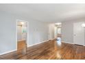 Spacious living room with hardwood flooring and multiple access doorways at 2453 Derby Dr, Raleigh, NC 27610