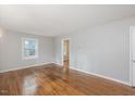 Bright living room features hardwood floors and natural light from the windows at 2453 Derby Dr, Raleigh, NC 27610