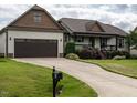 Attractive single-story home with an attached garage, manicured lawn and long driveway at 30 Imperial Dr, Clayton, NC 27527