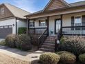 Inviting front porch with brick steps and decorative flower pots leading to the front door at 30 Imperial Dr, Clayton, NC 27527