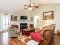 Cozy living room featuring a fireplace, wood floors, and comfortable seating arrangement at 30 Imperial Dr, Clayton, NC 27527