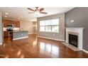 Open living room showcasing a fireplace, hardwood floors, and a view of the kitchen at 309 Mainline Sta, Morrisville, NC 27560