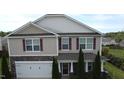 Two-story home featuring stone accents, attached two-car garage, and well-maintained landscaping at 401 Lawton Dr, Haw River, NC 27258