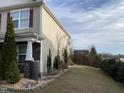 Manicured lawn extends to the side of the home, with stone accents and lush landscaping at 401 Lawton Dr, Haw River, NC 27258