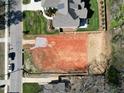 Birds eye view of a vacant lot with a neighboring home and cars, highlighting its location and surroundings at 405 Latimer Rd, Raleigh, NC 27609