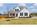 Charming two-story home with white siding, black shutters, and a well-manicured lawn at 4412 Beckel Rd, Willow Springs, NC 27592