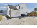 Exterior view of a home with a two car garage and a basketball hoop at 4412 Beckel Rd, Willow Springs, NC 27592