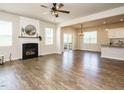 Open-concept living room with a fireplace, hardwood floors, and sliding glass doors leading to outdoor living at 50 Dover Ridge Ct, Chapel Hill, NC 27517