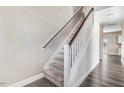 Carpeted stairway with white risers, wooden handrail, and natural light from a window at the top of the stairs at 500 Wakefield Dr, Princeton, NC 27569