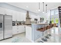 Bright kitchen showcasing a breakfast bar, stainless appliances, and stylish pendant lighting at 601 Lee St, Durham, NC 27701