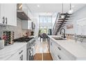 Modern kitchen features stainless steel appliances, white cabinets, and sleek countertops at 601 Lee St, Durham, NC 27701