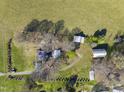 Aerial view of the house with an in-ground lawn sprinkler system and several outbuildings at 7055 Old 421 Rd, Liberty, NC 27298