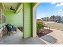 Covered front porch area featuring cozy seating and a view of the serene neighborhood street at 86 Pappy Ln, Garner, NC 27529