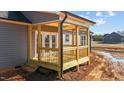 New wooden back porch with railing and steps at 9315 Turkey Way, Middlesex, NC 27557