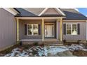 Inviting covered front porch with brick steps and wood columns at 9315 Turkey Way, Middlesex, NC 27557