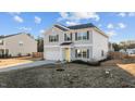 Well-maintained two-story home with gray siding, a yellow front door, and landscaping in a suburban neighborhood at 95 Westbrook Ln, Franklinton, NC 27525