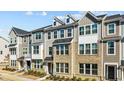 Beautiful townhome exterior featuring brick, siding, and dormer windows at 983 Parkstone Towne Blvd, Knightdale, NC 27545