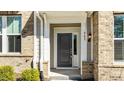 Inviting front door entrance with sidelight and modern exterior lighting at 983 Parkstone Towne Blvd, Knightdale, NC 27545