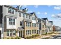 Charming street showcasing several townhomes with well-maintained landscaping at 983 Parkstone Towne Blvd, Knightdale, NC 27545