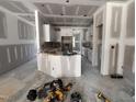 Open-concept kitchen with white cabinets and potential for a modern design, still under construction at 105 Tuskeegee Dr, Smithfield, NC 27577