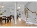Bright foyer features hardwood floors, stairs, and views into the formal dining and living areas at 1129 Sequoia Creek Ln, Cary, NC 27519