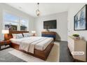 Stylish main bedroom with a large window, contemporary decor and hardwood furniture at 120 Breyla Way, Holly Springs, NC 27540