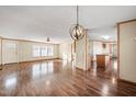 Open-concept layout showcasing the kitchen with modern appliances and fixtures, and wood flooring at 136 Pelham St, Haw River, NC 27258