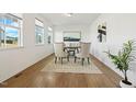 Bright dining room features hardwood floors, white walls, and natural light streaming through the windows creating an inviting atmosphere at 143 Rossell Park Cir, Garner, NC 27529