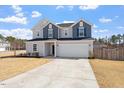 Well-manicured lawn with a two-story home, two-car garage and a double wide driveway at 171 Piney Field Rd, Fuquay Varina, NC 27526