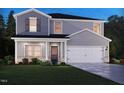 New two-story home with blue and gray siding, a well-manicured lawn, and an attached two-car garage at 1745 Pie Filling Dr, Haw River, NC 27258