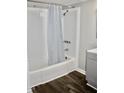 Bathroom featuring a shower with blue patterned curtain, gray walls, gray vanity and wood floors at 1960 Brogden Rd, Smithfield, NC 27577