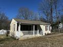 Cozy one-story home featuring a charming front porch with white railing at 2001 S Ashland Dr, Burlington, NC 27217