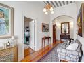 Traditional foyer with high ceilings, an ornate chandelier, hardwood floors, and an area rug at 206 S Salem St, Apex, NC 27502