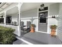 Inviting front porch with rocking chairs, grey flooring, and craftsman columns at 206 S Salem St, Apex, NC 27502