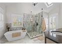 Elegant bathroom with a luxurious soaking tub, a glass enclosed shower, and natural light at 220 Epps Clark Rd, Siler City, NC 27344