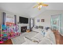 Bright living room featuring a fireplace, vaulted ceilings, and cozy decor at 23 Sparkle Ln, Garner, NC 27529