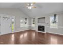 Inviting living room with fireplace, hardwood floors, vaulted ceilings, and ample natural light at 23 Sparkle Ln, Garner, NC 27529