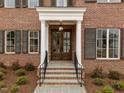 Elegant front entrance with double doors, stone steps, and stylish railings at 2623 Marchmont St, Raleigh, NC 27608