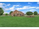 Expansive backyard with lush lawn and stone fireplace, perfect for outdoor entertaining and relaxation at 296 Shoreline Dr, Princeton, NC 27569