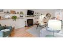 Cozy living room with a decorative fireplace, stylish furnishings, and hardwood flooring at 3212 Oxford Dr, Durham, NC 27707