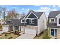 A two-story home with a stone facade, showcasing its side yard and clean lines at 44 Fairwinds Drive Dr, Lillington, NC 27546
