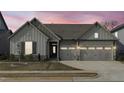 Charming home featuring a three car garage, stone accents, a well kept lawn, and board and batten siding at 50 Sneed Ln, Fuquay Varina, NC 27526