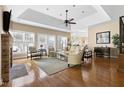 Bright living room featuring hardwood floors, a stone fireplace, and large windows for ample natural light at 50002 Brogden, Chapel Hill, NC 27517