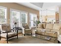 Bright living room showcasing a neutral color palette, large windows, and comfortable seating arrangements at 50002 Brogden, Chapel Hill, NC 27517