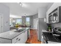Modern kitchen with stainless steel appliances, granite countertops, and open layout to living area at 506 N Mangum St # 303, Durham, NC 27701