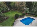 Inviting backyard with a sparkling in-ground swimming pool and comfortable lounge chairs at 515 S Woodland Rd, Henderson, NC 27536