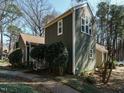 View of this wonderful two-story home with an exterior showcasing green siding and lots of beautiful windows at 5917 Sentinel Dr, Raleigh, NC 27609